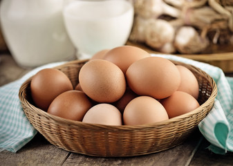 Easter egg in a basket on wodden table