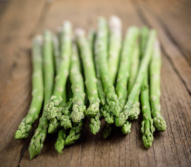 fresh green asparagus on wooden background