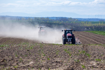 Tractor harrowing the field