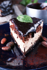 Delicious chocolate cake with icing in plate on table, closeup
