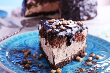 Delicious chocolate cake with icing in plate on table, closeup