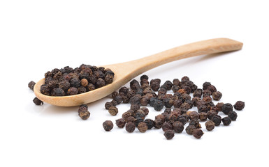 Black pepper in wooden spoon on white background.