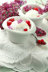 Beautiful composition with tasty ice cream and lilac flowers
