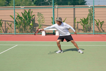 Fototapeta premium senior 59s years old man playing tennis in sport club