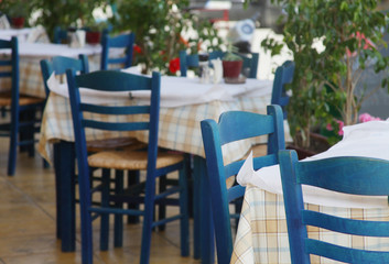 Blue chairs on a greek cafe