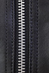 Close - up Metal sliver zip on leather bag..