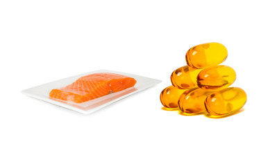 Fish oil supplement product capsules with salmon on dish