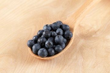Blueberries in a wooden spoon