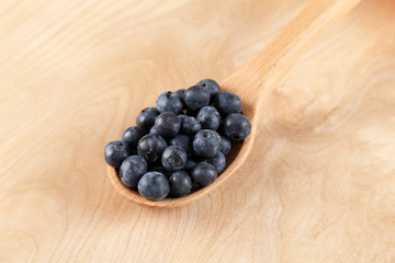 Blueberries in a wooden spoon