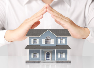 Businessman holding home model