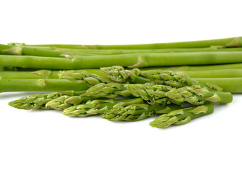 stack of fresh green asparagus on white background