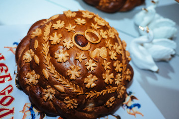 Traditional ukrainian wedding bread on an embroidery towel.