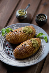 Hasselback potatoes with fresh pesto sauce, studio shot