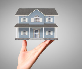 Businessman holding home model