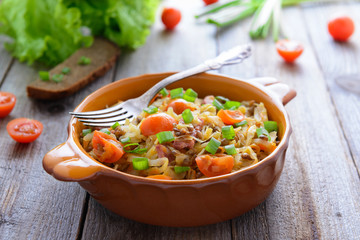 Stewed cabbage with tomatoes, onions and sausages