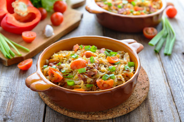 Stewed cabbage with tomatoes, onions and sausages