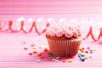 Birthday cupcake with butter cream on colorful background