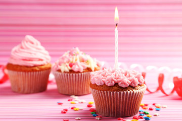 Birthday cupcake with butter cream and candle 