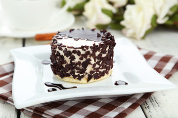 Cake on plate, on the white wooden background