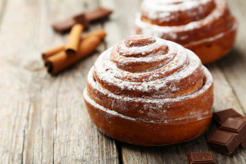 Cinnamon buns on grey wooden background