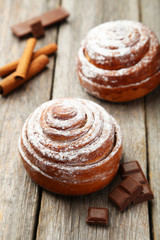 Cinnamon buns on grey wooden background