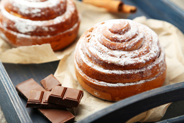 Cinnamon buns with chocolate in blue tray