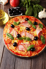 Delicious fresh pizza on brown wooden background