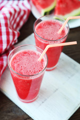 Watermelon smoothies on brown wooden background