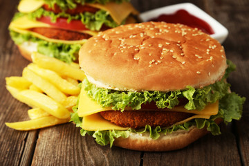 Big burger on brown wooden background