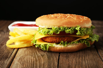 Big burger on brown wooden background