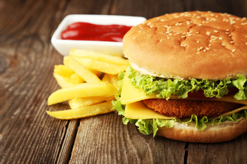 Big burger on brown wooden background