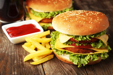 Big burgers on brown wooden background
