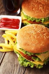 Big burgers on brown wooden background