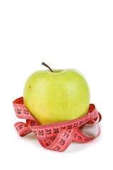 Green apple with measuring tape isolated on white