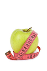 Green apple with measuring tape isolated on white