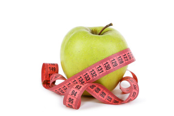 Green apple with measuring tape isolated on white