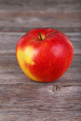 Red apple on grey wooden background