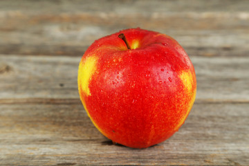 Red apple on grey wooden background