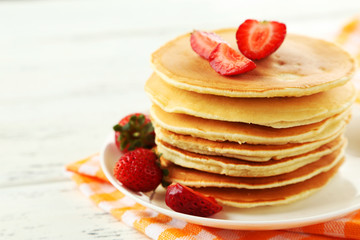 Delicious pancakes with on white wooden background