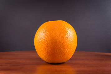 Single Orange on Wood