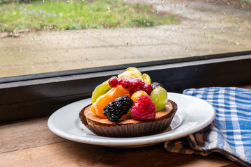 fresh fruit pie tart with kiwi, blueberry, orange and strawberry