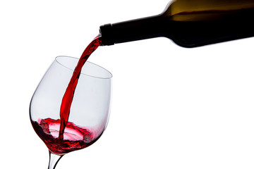 wine is poured into a glass on a white background