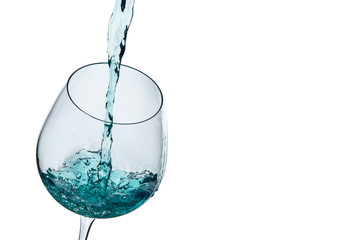 Water poured into a glass on a white background