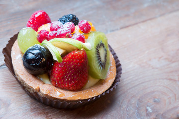 fresh fruit pie tart with kiwi, blueberry, orange and strawberry