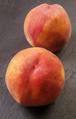 Fototapeta na wymiar Close up shot of a fresh peach isolated on a black background