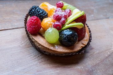 fresh fruit pie tart with kiwi, blueberry, orange and strawberry