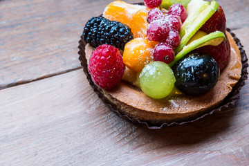 fresh fruit pie tart with kiwi, blueberry, orange and strawberry