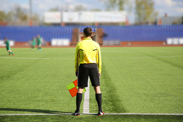 Football. Linesman in yellow jersey