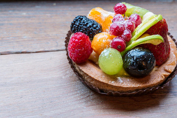 fresh fruit pie tart with kiwi, blueberry, orange and strawberry