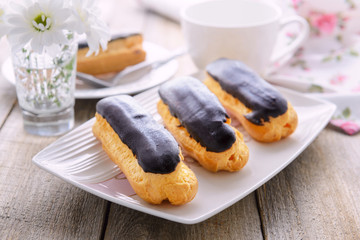 Three eclairs with custard om white plate